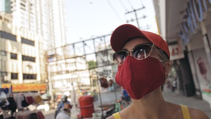 Woman travel caucasian visitor at a supermarket with wearing protective medical mask. Girl tourist customer a grocery store with protect respirator. Virus protection coronavirus pandemic covid-19.