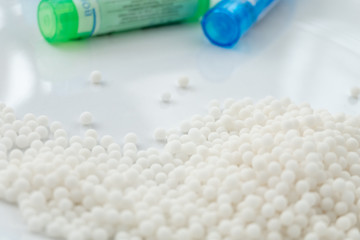 Homeopathy medicine Bottles and granules isolated on a White Background
