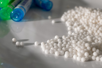 Homeopathy medicine Bottles and granules isolated on a White Background
