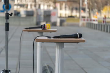 Microphone on table outdoors. Focus on foreground