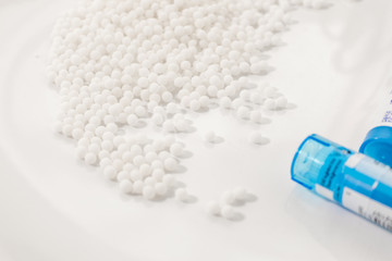 Homeopathy medicine Bottles and granules isolated on a White Background