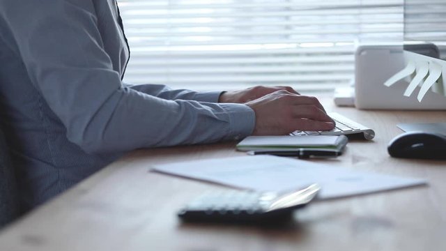 business plan, financial simulation, businessman working on computer in office, hands typing on keyboard