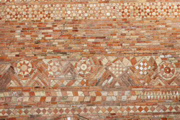 Ancient brick wall of the Basilica of Santo Stefano also called the Seven Churches in early Christian, Romanesque and Gothic style. Bologna, Emilia-Romagna, Italy, Europe