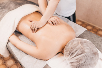 Massage of the longitudinal muscles of the back - patient at the medical center - massage parlor