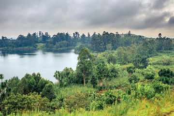 View of green mountains with a Crater Lake and the reflections on the water on a cloudy overcast...