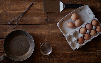 Chicken eggs in the pack on the dark wooden 