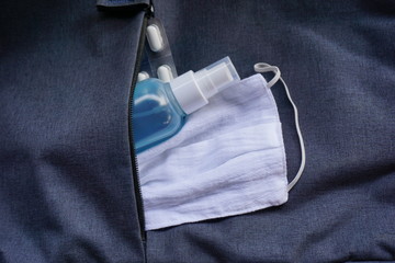 Sanitizing  spray  hand  cleaner  with  cotton  white  mask.