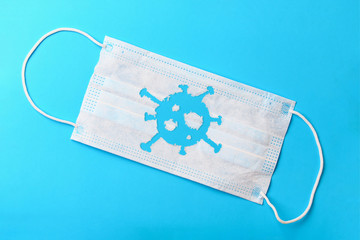 Medical mask torn in the abstract form of a virus on a blue background. The concept of the...