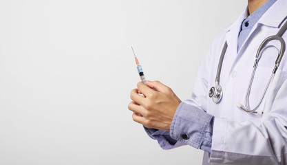 doctor hand holding vaccine syringe in gray wall background and copy space. Concept Preventive measures against corona virus.
