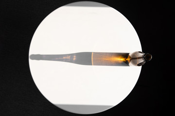top view shadow from a glass bottle on a white table