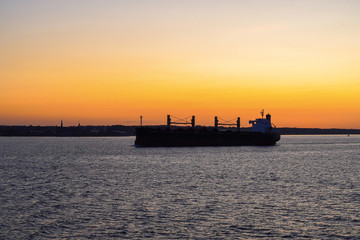 Cargo ships in sunset light