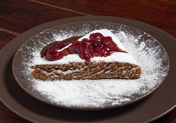 A piece of cake with strawberry jam and sugar. Dessert, food, sweet, baking. Biscuit, brownie, tiramisu, cheesecake. Cook at home, homemade, closeup, Bakery products.