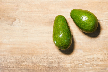 The beautiful green avocados on a wooden background. Healthy vegan diet, healthy breakfast