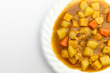 Curry with vegetables on white background