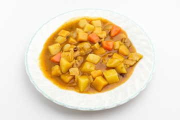 Curry with vegetables on white background