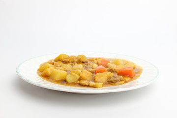 Curry with vegetables on white background