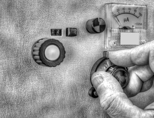 Close up view of radio amateur tuning the high frequency power amplifier in black and white