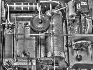 Inside view of high frequency power amplifier with capacitors, coils and other components in black...