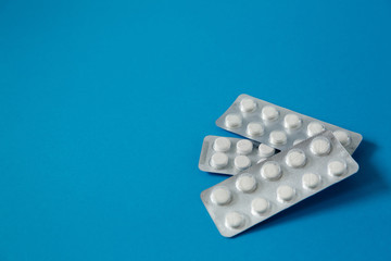 pills in blister pack on blue background