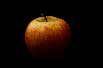 red apple on black background