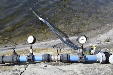 Air pressure sensor on compressor and iron tap on blue plastic pipe.