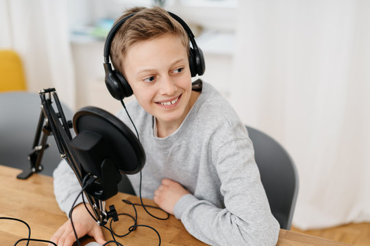 Teenager Boy Recording Podcast At Home