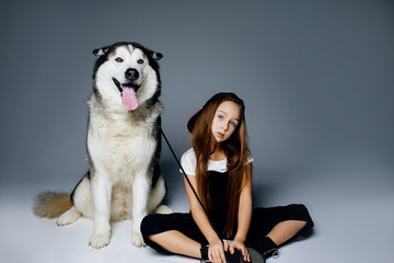 teen girl sitting on the floor with her dog