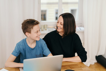 Young teenage boy smiling at his mother