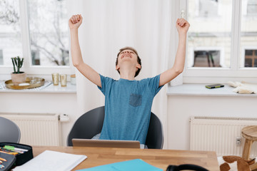 Obraz premium Young boy rejoicing and cheering after good news
