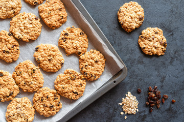 Homemade oatmeal cookies with raisins on a dark background