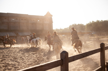 horses jumping near the castle at sunset