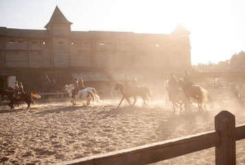 horse riders near the castle at sunset
