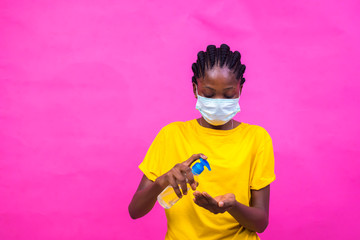 young black lady wearing a nose mask to prevent her from a pandemic and also holding a hand...