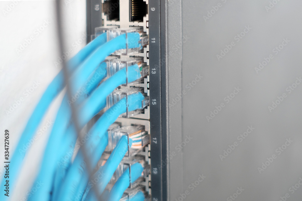 Poster hub with many lan cables plugged in,network computer concept