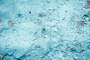 Concrete gray wall with peeling blue paint texture or background. High contrast and resolution image with place for text. Template for design