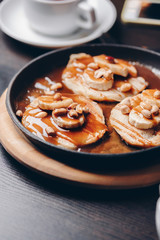 Obraz na płótnie Canvas pancakes with peanuts and caramel sauce