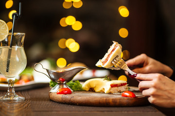 Romantic festive dinner, hands with appliances, cocktail, horizontal, side view