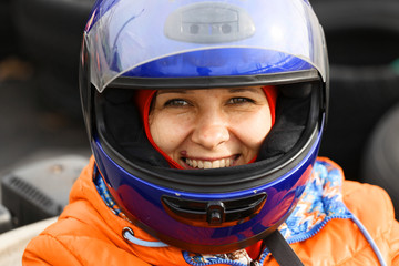 girl is driving Go-kart car with speed in a playground racing track.