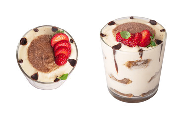 tiramisu in a glass with berries, mint and coffee beans on a light wooden background