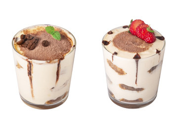 tiramisu in a glass with berries, mint and coffee beans on a light wooden background