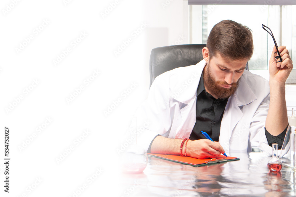 Poster a man works in a laboratory. place for text next to the laboratory assistant. a man in a white coat 