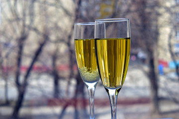 Two glasses of champagne on the background of a bokeh street