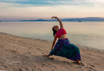 Asian Thai woman practicing yoga in Haad Seekantang beach, Koh Phangan island, Thailand