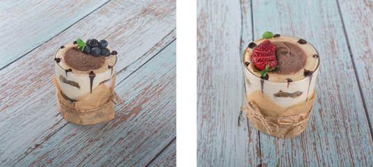 tiramisu in a glass with berries, mint and coffee beans on a light wooden background