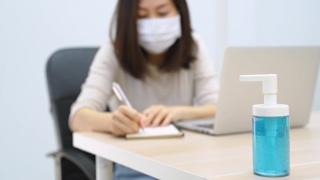 Adult asian businesswoman working from home and wearing mask for prevention of pandemic Covid-19 and Coronavirus, healthcare and business concept
