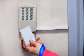Electronic door lock, opening by security card. lady opening an electronic door lock by a security card