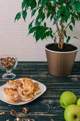 Cinnamon rolls are on a plate. Apple crumble on white dish and fresh green apple. Easy and Basic dessert menu.