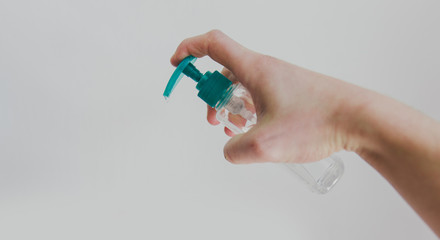Male hand using sanitizer to disinfect from Covid-19 bacteria. 