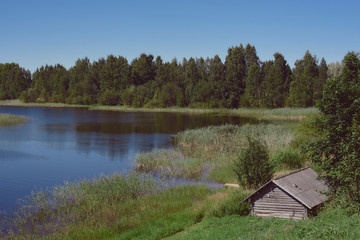 old wooden house in the forest by the lake