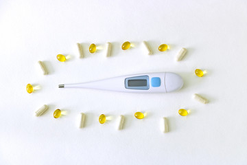 Digital thermometer surrounded by medications